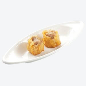 2 pieces of Siomai served inside the curved shaped white dish